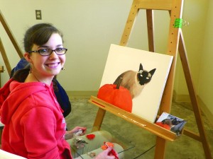 Girl painting cat      
